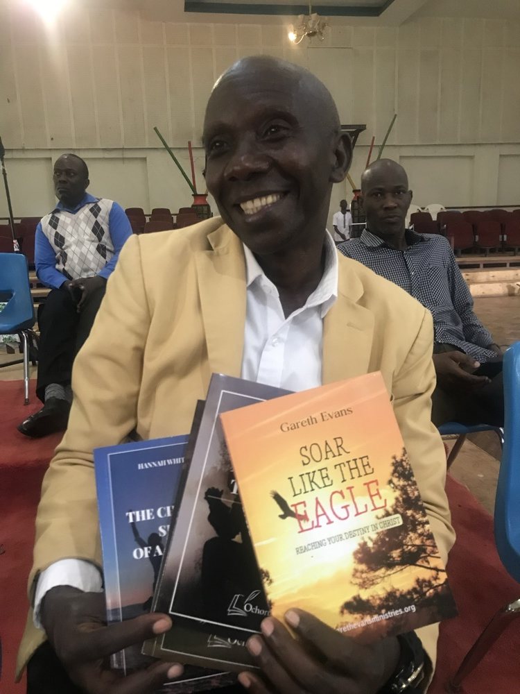 Un pasteur ougandais avec son exemplaire de Soar Like the Eagle, écrit par Gareth Evans.