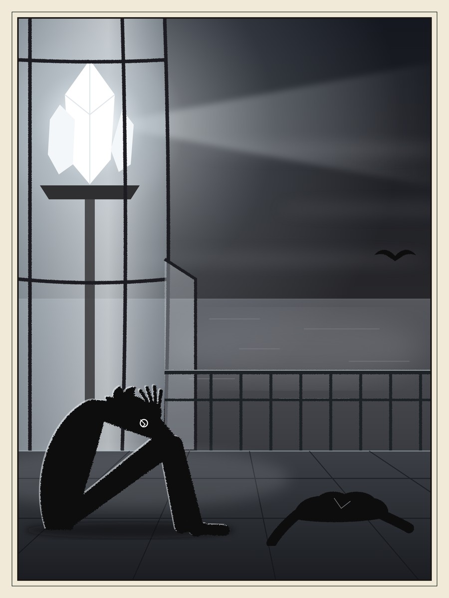 A boy sits on the floor of a lighthouse gallery with his knees up and his face buried in his hands, one cracked spectacle lens showing. Above him a huge white crystal blazes behind glass, an empty coat lies on the floor, and a gull flies over the grey sea.